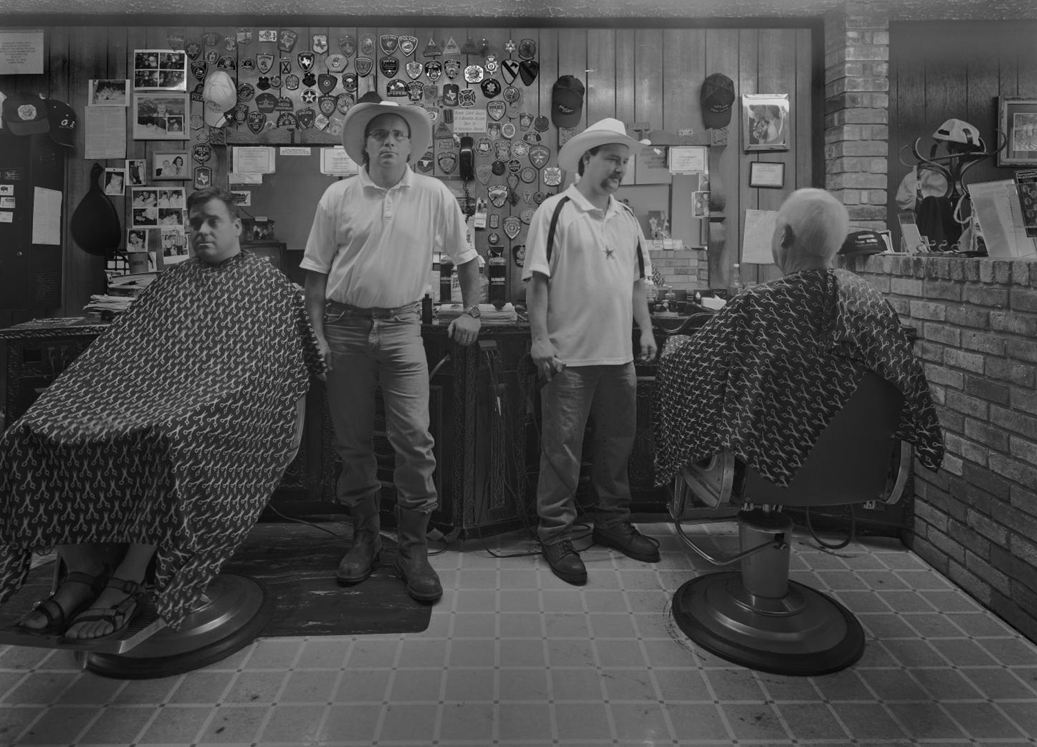 Randy and James Russell, Jr. with customers at Plano Barbers in late 1990s // courtesy Byrd M. Williams, IV