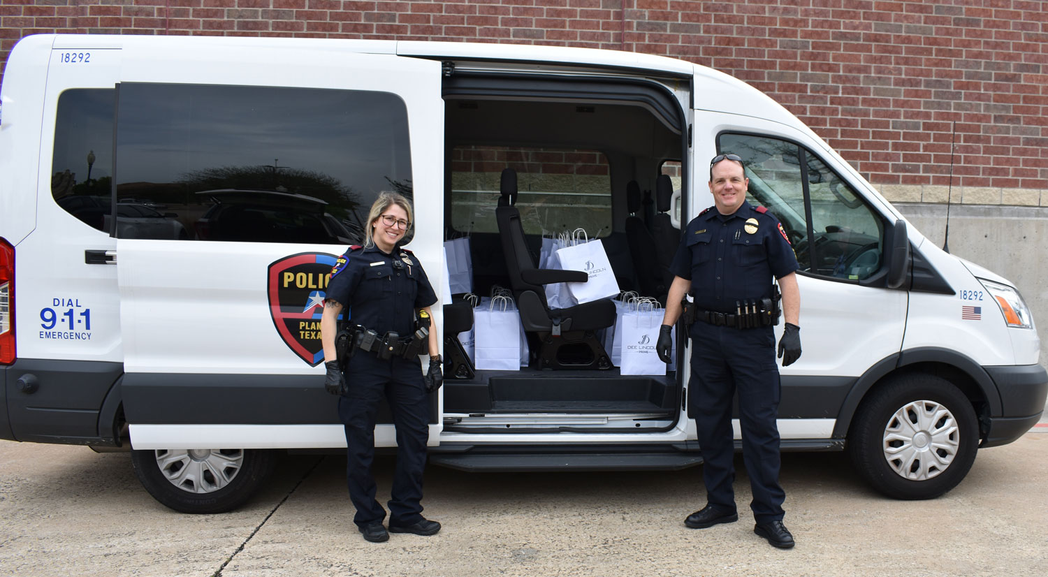 Officer Hayley Dick and Sergeant Wes Gerig with the crime prevention van loaded to deliver lunches to three substations // courtesy St. Andrew UMC