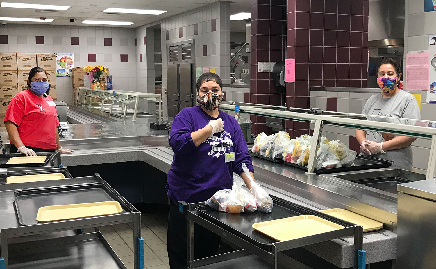 Food and Nutritional Services employees at Meadows Elementary package grab-and-go meals for students // courtesy Plano ISD