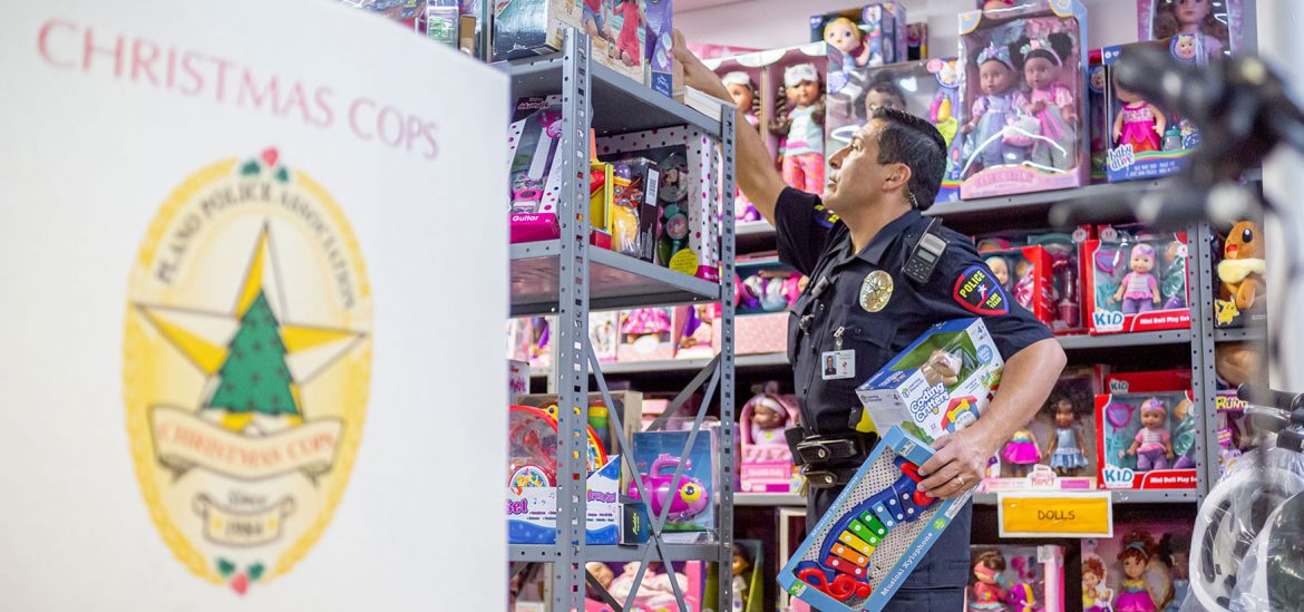 Plano Police Officer Isaac Soto sorts toys for Christmas Cops // photos Jennifer Shertzer
