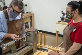 Richardson Mayor Paul Voelker gets a lesson from Kathy Falgout in turning a pen // courtesy TheLab.ms