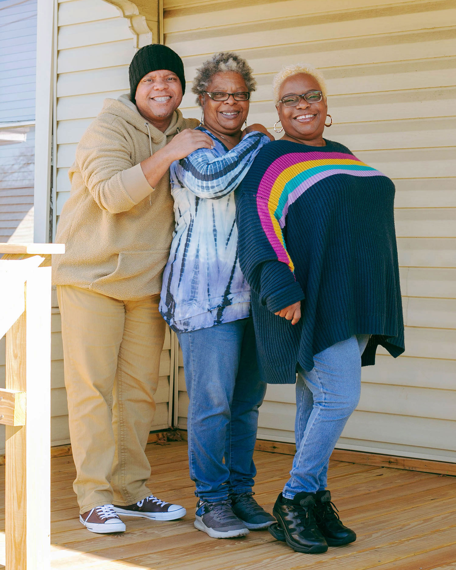 Siblings David Evans, Andrea Brooks and Tamara Thomas on Andrea's porch in the Douglass Community // photo Hunter Lacey