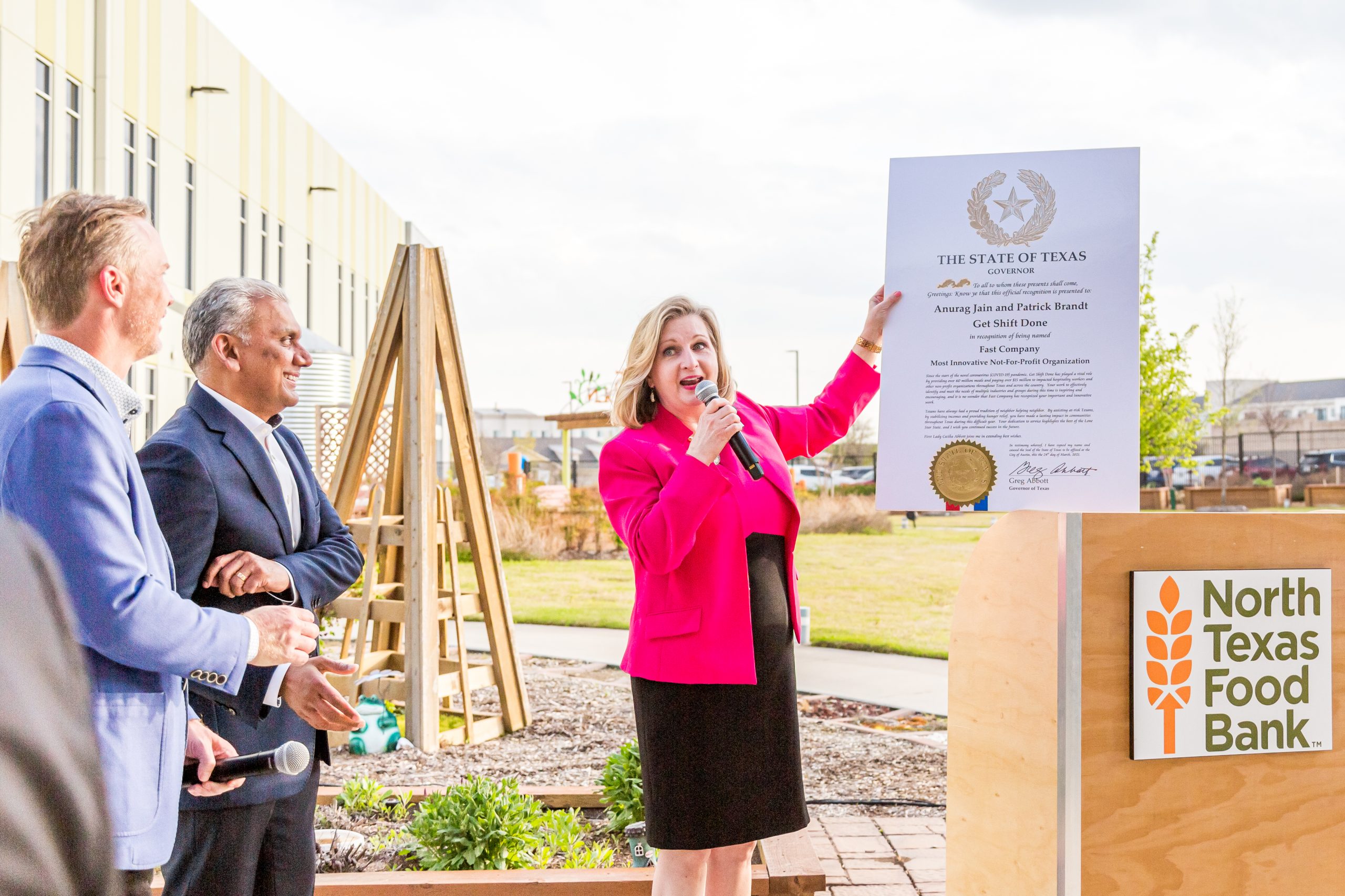North Texas Food Bank President Trisha Cunningham presents special recognition from Governor Greg Abbott // photos Jennifer Shertzer