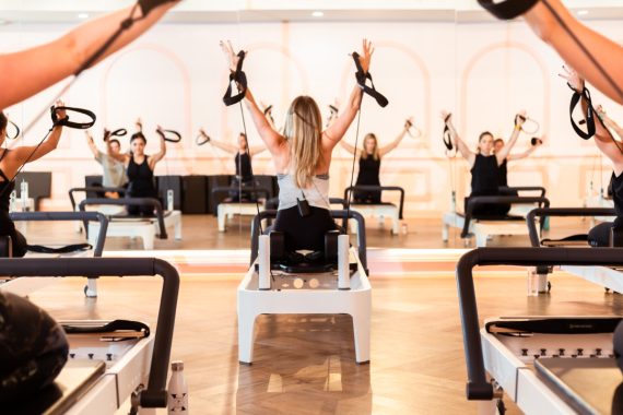 Sponsored Content: Plano’s SESSIONS Pilates’ owner Brittany Grignon leads a reformer class. Photo by Jessica Turner