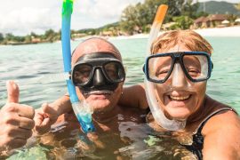 Senior couple snorkeling