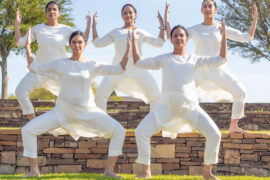 Garage Arts Project. dancers in white against a blue sky