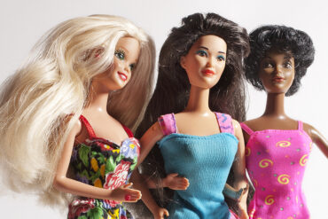A studio shot of three vintage Barbie dolls of different ethnicity. Barbie dolls are have been manufactured by Mattel, Inc. since1959.