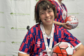 Woman smiles participating in North Texas United Soccer League (NTUSL) which brings friendly competition between HIPsters (Hugely Important People) and community members.. Photo courtesy of My Possibilities