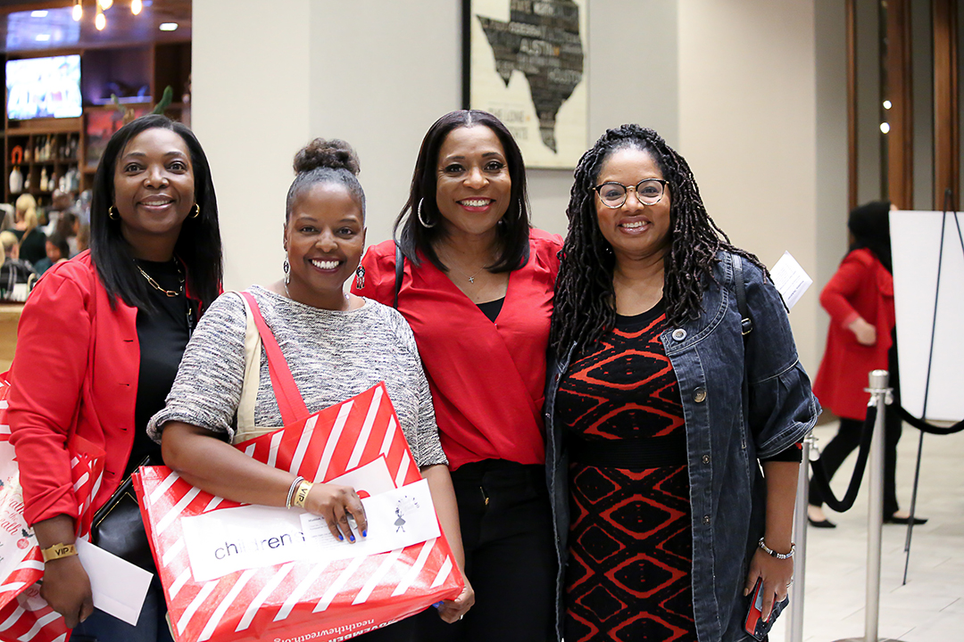 Three women smiling at the Junior League of Collin County’s annual ’Neath the Wreath holiday market and gift. Photo courtesy of Junior League of Collin County
