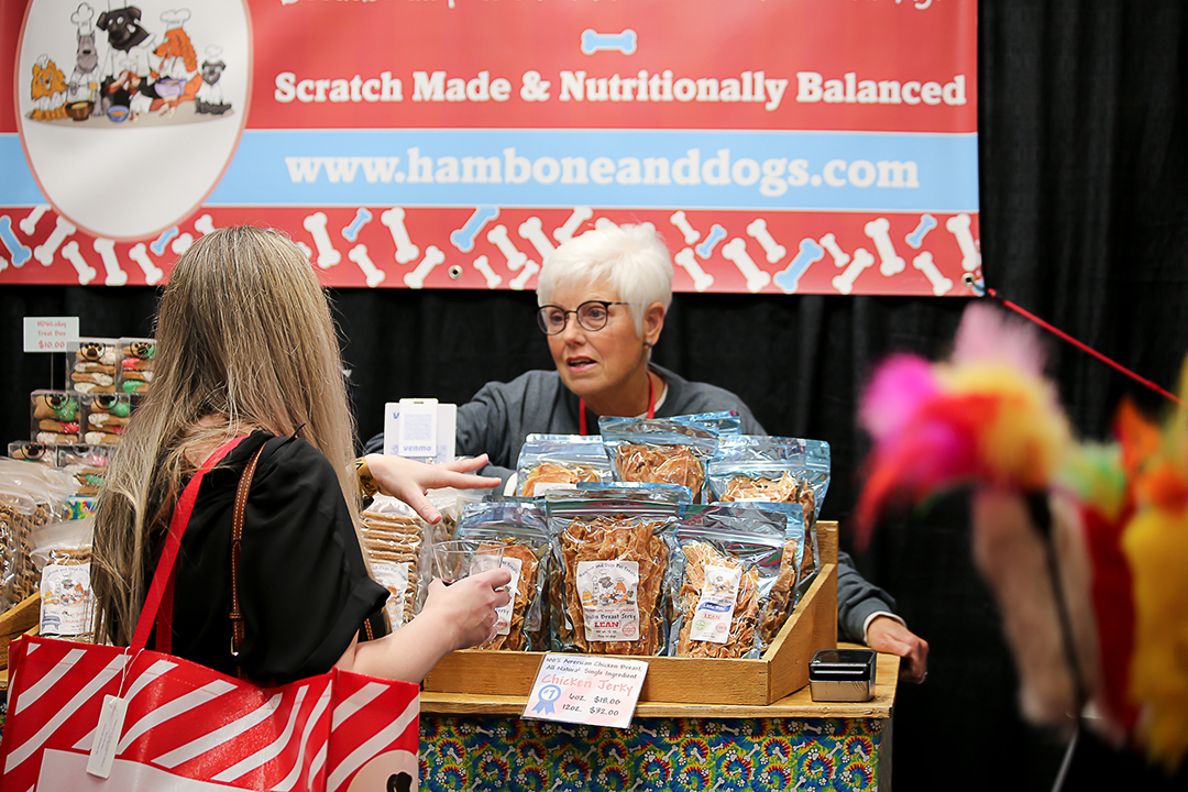 A vendor offers samples of gormet goods at Junior League of Collin County’s annual ’Neath the Wreath holiday market and gift. Photo courtesy of Junior League of Collin County