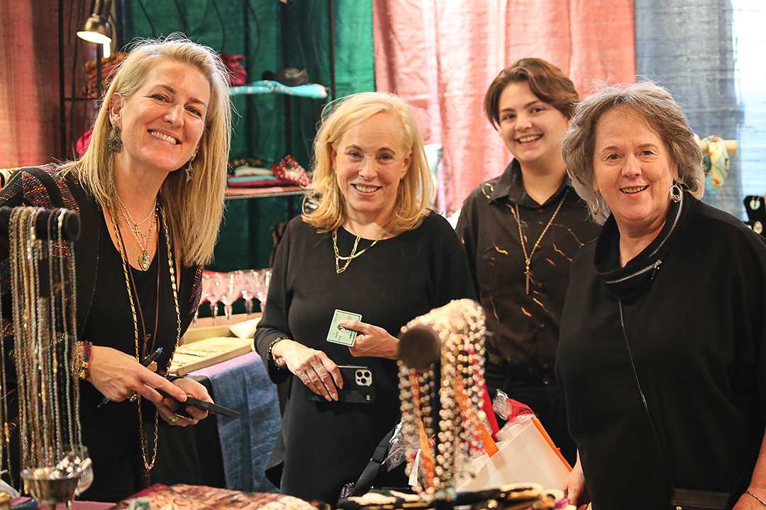 4 women smiling and shopping at Junior League of Collin County’s annual ’Neath the Wreath holiday market and gift. Photo courtesy of Junior League of Collin County