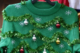 Getty image of ugly sweater with green garland and ornaments