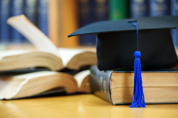 Graduation cap and books. Getty image. Photo by nirat.