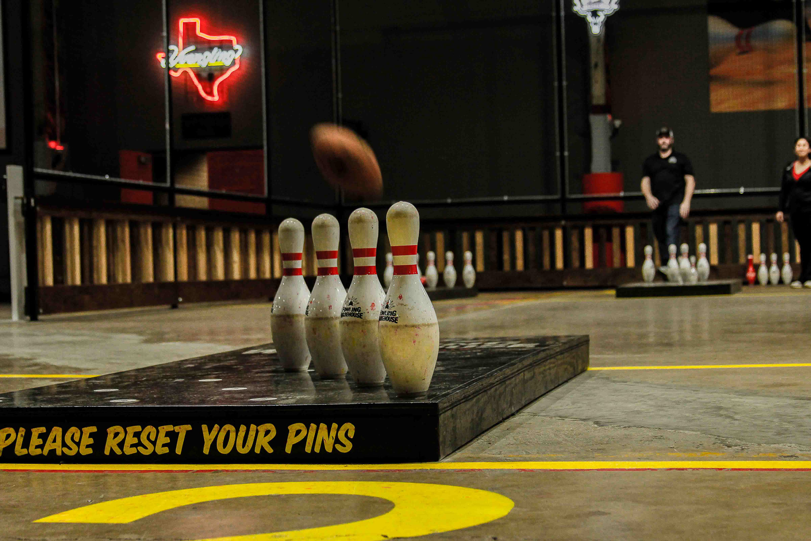 Bowling pins about to be hit by a football at Fowling Warehouse photography Kelsey Shoemaker