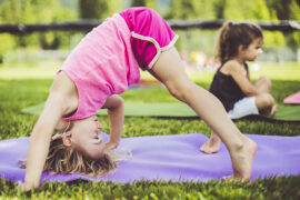 Getty Children concentrating on exercises and balance in grass.