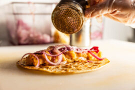 The Aloo Masala Roll contains a mashed potato patty with tomatoes, green peppers and spices in a paratha roll. Photo Kathy Tran