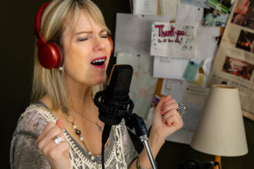 Julie Ann Kennedy records a song. Photo by Yuvie Styles