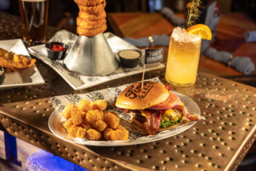 A burger with tots, onion rings and a beer at Ford's Garage. Photo by KathyTran.