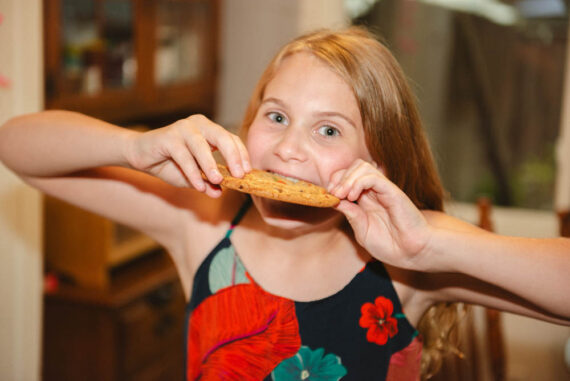 Arya Hinkley bites a gian cookie from Hinkley House Bakery.