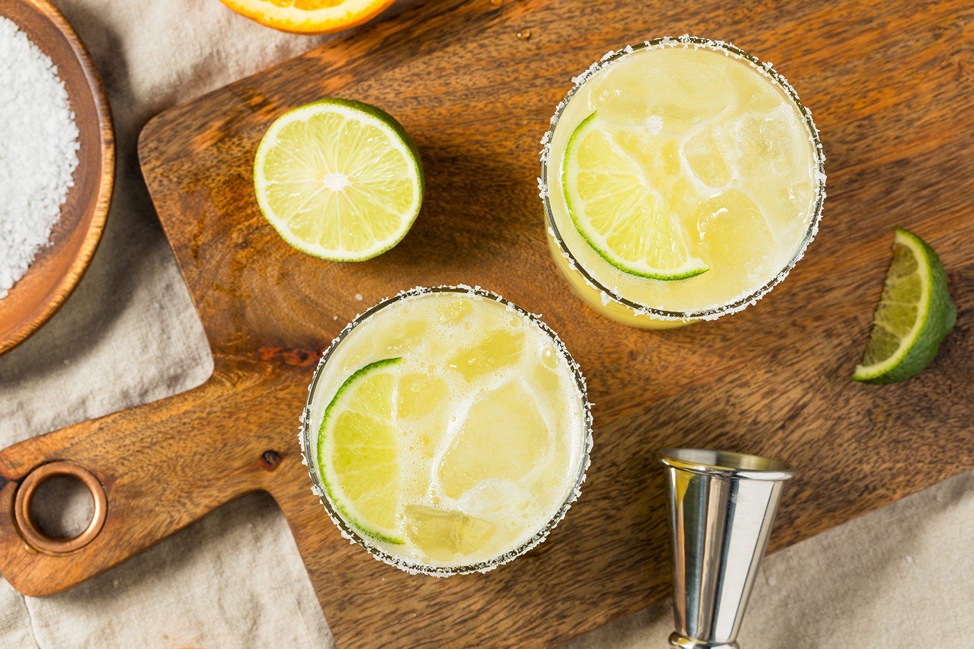 Margaritas from above with limes and barware.