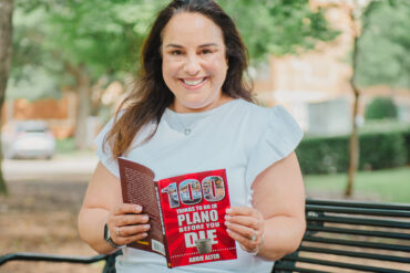 Abbie Alter with her book "100 Things to Do in Plano Before You Die." Photography by Lauren Allen