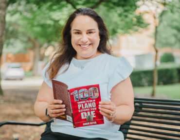 Abbie Alter with her book "100 Things to Do in Plano Before You Die." Photography by Lauren Allen